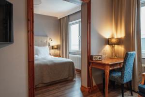a bedroom with a bed and a table with a mirror at Home Hotel Smedjan in Sandviken +66 photos