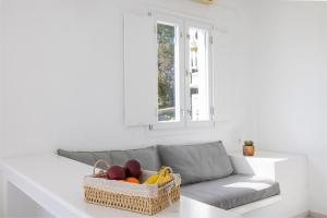 a living room with a couch with a basket of fruit at Villa Anthemoessa - Endless Seaview in Pythagoreio