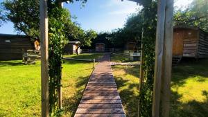 a path through a garden with a pergola at Orchard Hideaways, Penrith, The Lake District in Penrith