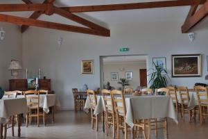 a dining room with tables and chairs and wooden beams at Hôtel restaurant Le Belvedere De Coti in Coti-Chiavari +16 photos