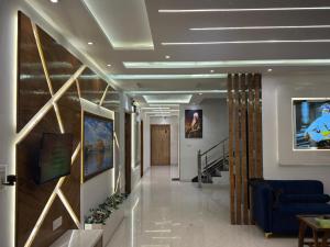 a hallway in a hospital with paintings on the walls at Hotel Silver Bricks in Amritsar