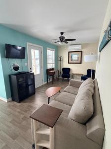 a living room with a couch and a flat screen tv at Drift Ashore House in Rocky Harbour