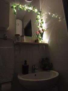 a bathroom with a sink and a mirror with lights at Kuća za odmor-Aleksandra in Divčibare +77 photos