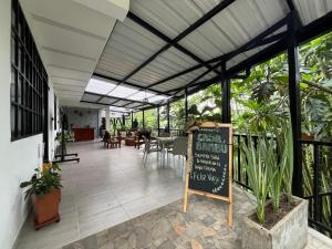 a restaurant with a sign in the middle of a building at Hotel Casa Bambu in Calima