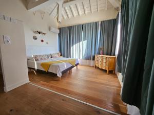 a bedroom with a bed and a wooden floor at Mas de la tour de rey in Canet-en-Roussillon +185 photos