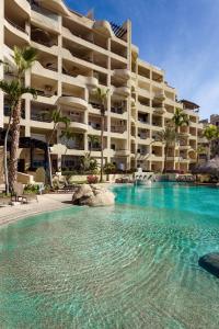 a swimming pool in front of a hotel at Apartamento en Los Cabos - Misiones del Cabo in Cabo San Lucas