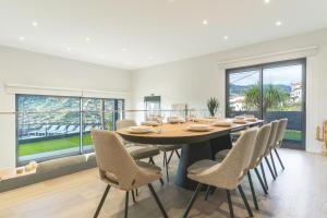 a dining room with a large table and chairs at Villa Sofia by Atlantic Holiday in Machico