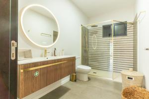 a bathroom with a sink and a toilet and a mirror at Villa Sofia by Atlantic Holiday in Machico +25 photos