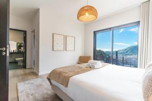 a bedroom with a large bed and a large window at Villa Sofia by Atlantic Holiday in Machico