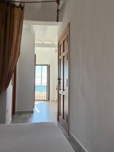 a room with an open door with a bed in it at H&B COSTABLANCA in Villajoyosa