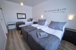 a hotel room with two beds with towels on them at Lynghagi House in Vegamót +4 photos