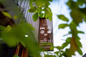 a sign hanging on the side of a building at Nest & Rest in Sri Jayewardenepura Kotte +33 photos