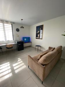 a living room with a couch and a table at Heshima's Apartment for Business in Macouria