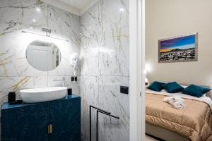 a bathroom with a sink and a bed in it at ZapataRelais in Naples +57 photos