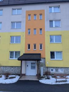 a building with a bench in front of it at Summit Suite in Vysoké Tatry