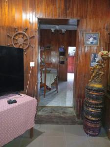 a living room with a table and a television at Antique Villa in Gampola