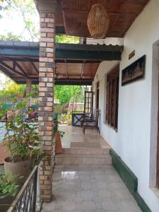 a porch of a house with a wooden roof at Antique Villa in Gampola