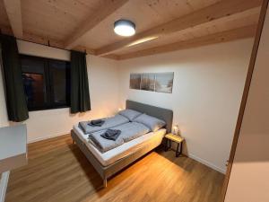 a bedroom with a bed in the middle of a room at Apartmánový dom DK Ateliér in Dolný Kubín