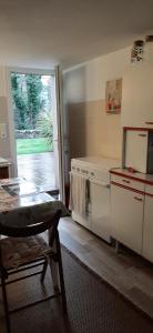 a kitchen with a stove and a door to a yard at Chambre d hôtes in Crach