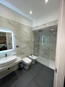 a bathroom with a sink and a toilet and a shower at Li Cumpari salentini in Lecce +60 photos