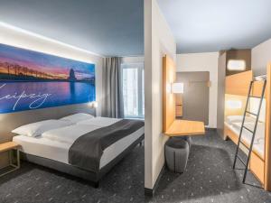 a bedroom with a bed and a bunk bed at B&B Hotel Leipzig-City in Leipzig +23 photos