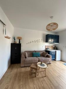 a living room with a couch and a table at Studio cosy in Frontignan