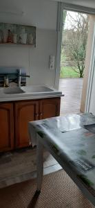 a kitchen with a table and a sink and a counter at Chambre d hôtes in Crach +10 photos