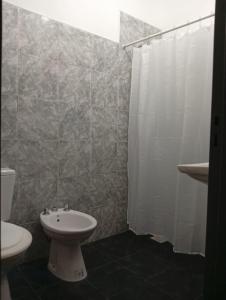a bathroom with a sink and a toilet and a shower at Refugio Blue Hill in Villa Cerro Azul +11 photos