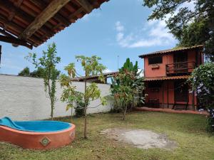 a view of a house with trees and a tub at Praia Chalé Ubatuba in Ubatuba