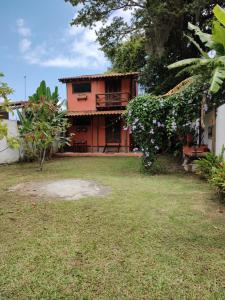 a house with a large yard in front of it at Praia Chalé Ubatuba in Ubatuba