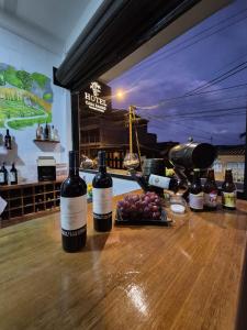 two bottles of wine sitting on top of a wooden table at Hotel Casa Bambu in Calima