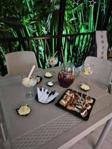 a table with food and wine glasses on it at Hotel Casa Bambu in Calima +14 photos