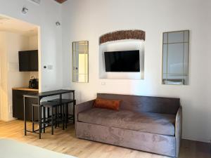 a living room with a couch and a table at Palazzo Garbusi in Sarzana
