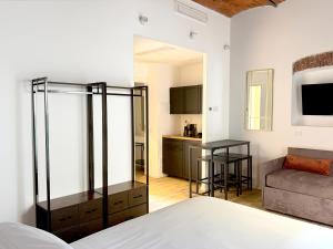 a room with a bed and a living room with a couch at Palazzo Garbusi in Sarzana