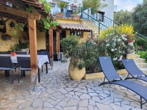 a patio with a table and chairs and flowers at Soleillas in Vence