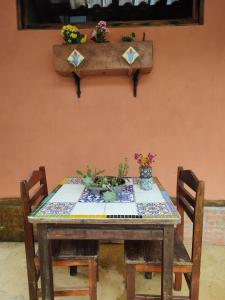 a table with two chairs with flowers on it at Praia Chalé Ubatuba in Ubatuba