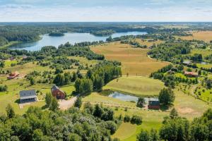 an aerial view of a farm and a lake at Privatus namelis gamtoje greta Trakų in Daugirdiškės +17 photos