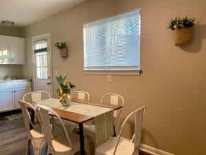 a dining room with a table and white chairs at Hillside Haven - affordable and convenient in Chattanooga