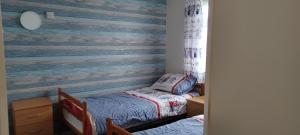a bedroom with a stripped wall with a twin bed at alicias chalets ,free WIFI & swimming pool passes in Great Yarmouth