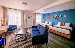 a hotel room with two beds and a couch at Kettle Valley Beach Resort in Penticton
