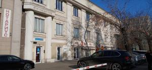 a black car parked in front of a building at Pulse capsule hotel in Almaty