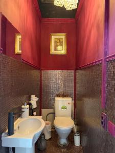 a bathroom with a toilet and a sink at Pulse capsule hotel in Almaty +15 photos