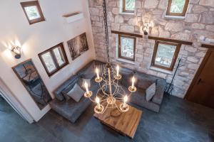 an overhead view of a living room with a chandelier at Pelion Villa Serenity View in Pouríon