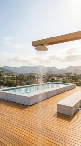 a swimming pool on the deck of a house at Apartamento do Paulão in Ubatuba