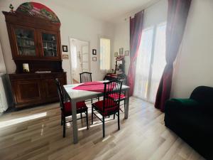 a dining room with a table and chairs in a room at Suite Semeria 38 - Sanremo in Sanremo