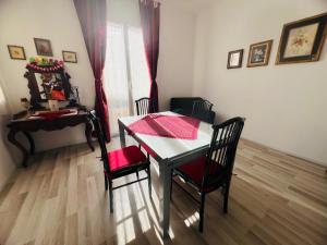 a dining room with a table and two chairs and a table and a desk at Suite Semeria 38 - Sanremo in Sanremo +12 photos