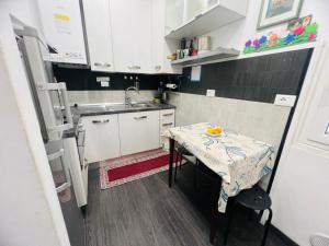 a small kitchen with a table and a sink at Suite Semeria 38 - Sanremo in Sanremo
