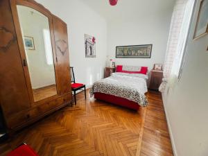 a bedroom with a bed and a mirror in it at Suite Semeria 38 - Sanremo in Sanremo