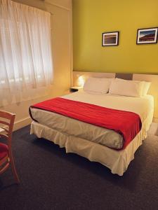 a bedroom with a large bed with a red blanket at Estepa Hotel in General Roca +55 photos