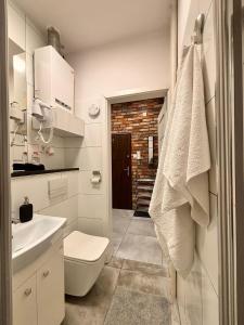 a bathroom with a white toilet and a sink at Apart Brzeg in Brzeg +53 photos